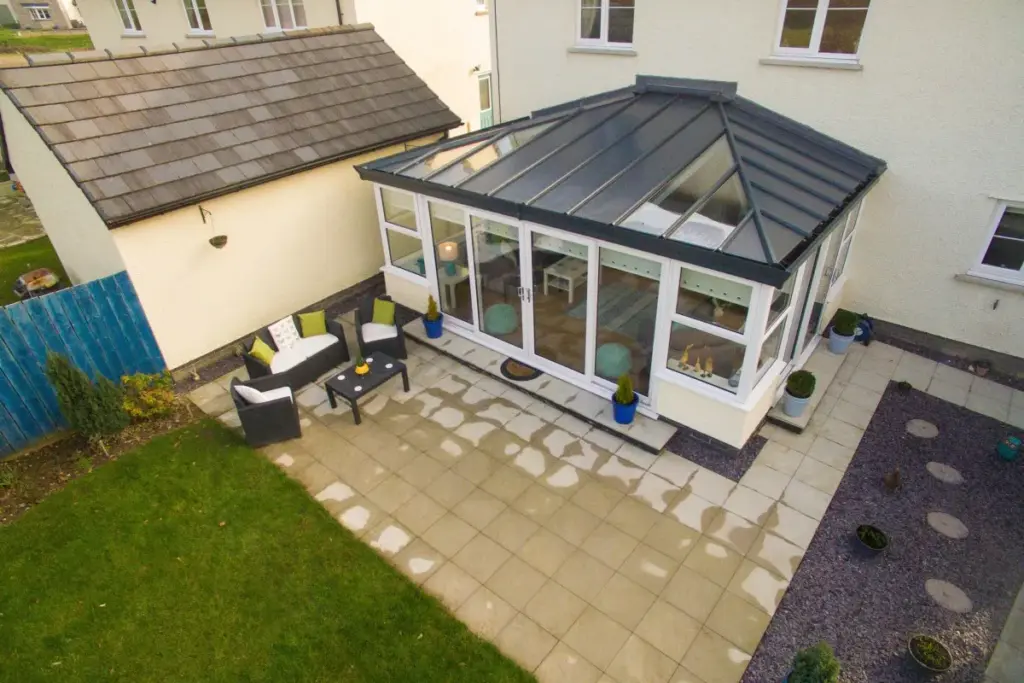 white conservatory with grey polycarbonate roof