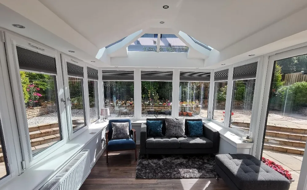 double hipped conservatory with chairs and carpet