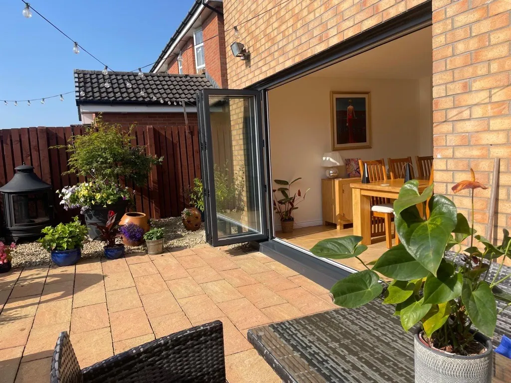 grey bi fold door & drain installation yellow brick house