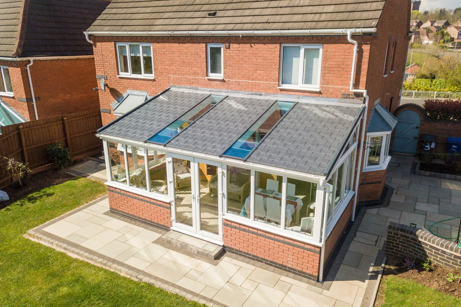 tiled lean to conservatory with brick wall and roof windows
