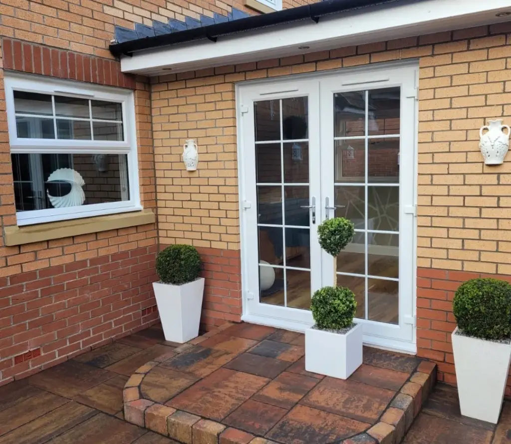 white pvcu french door on yellow brick wall