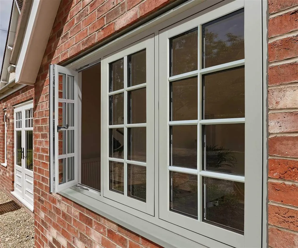 white upvc flush and shash window opened red brick house