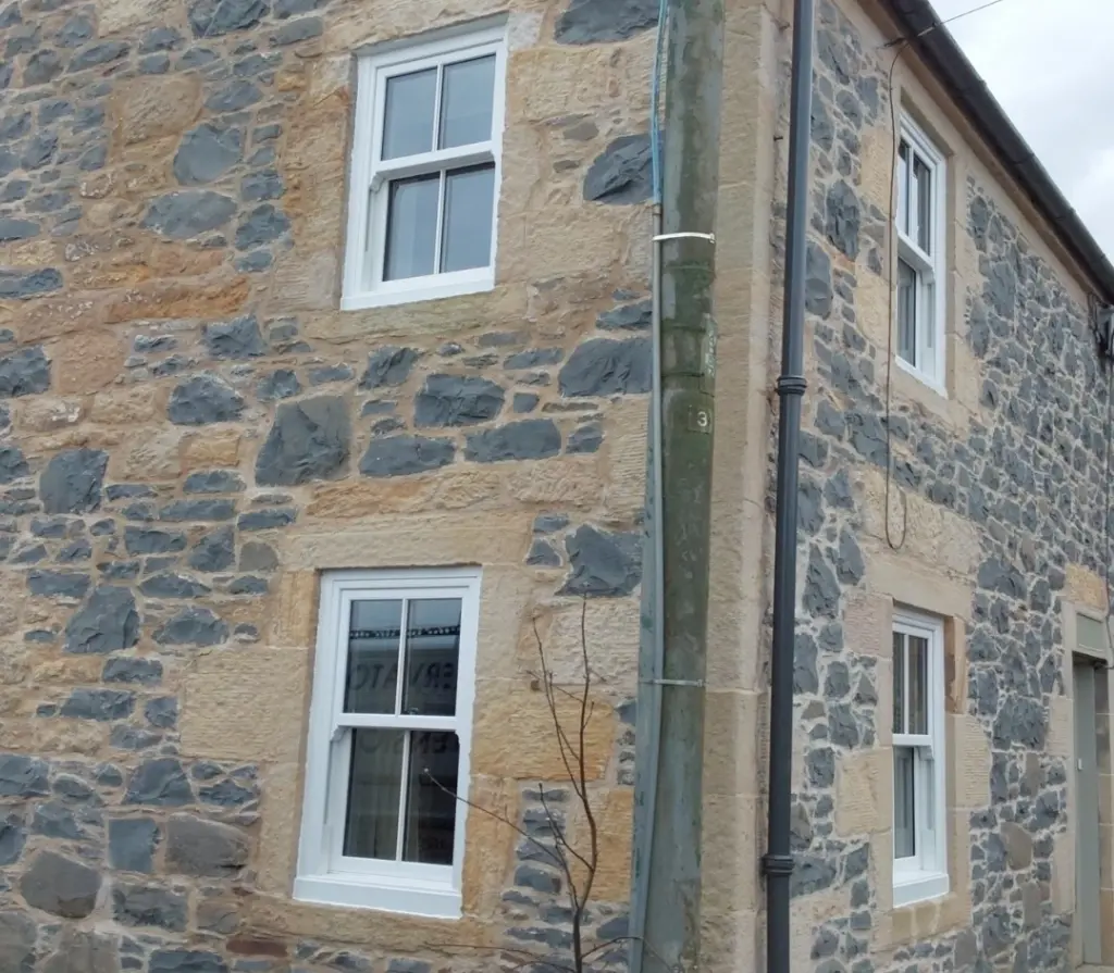 white upvc sliding sash and case windows on farm house