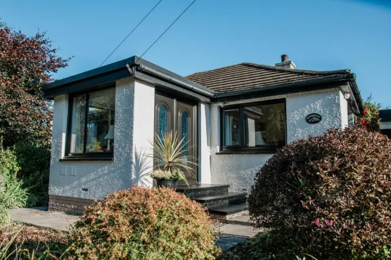 bugalow with brown french door and casement windows