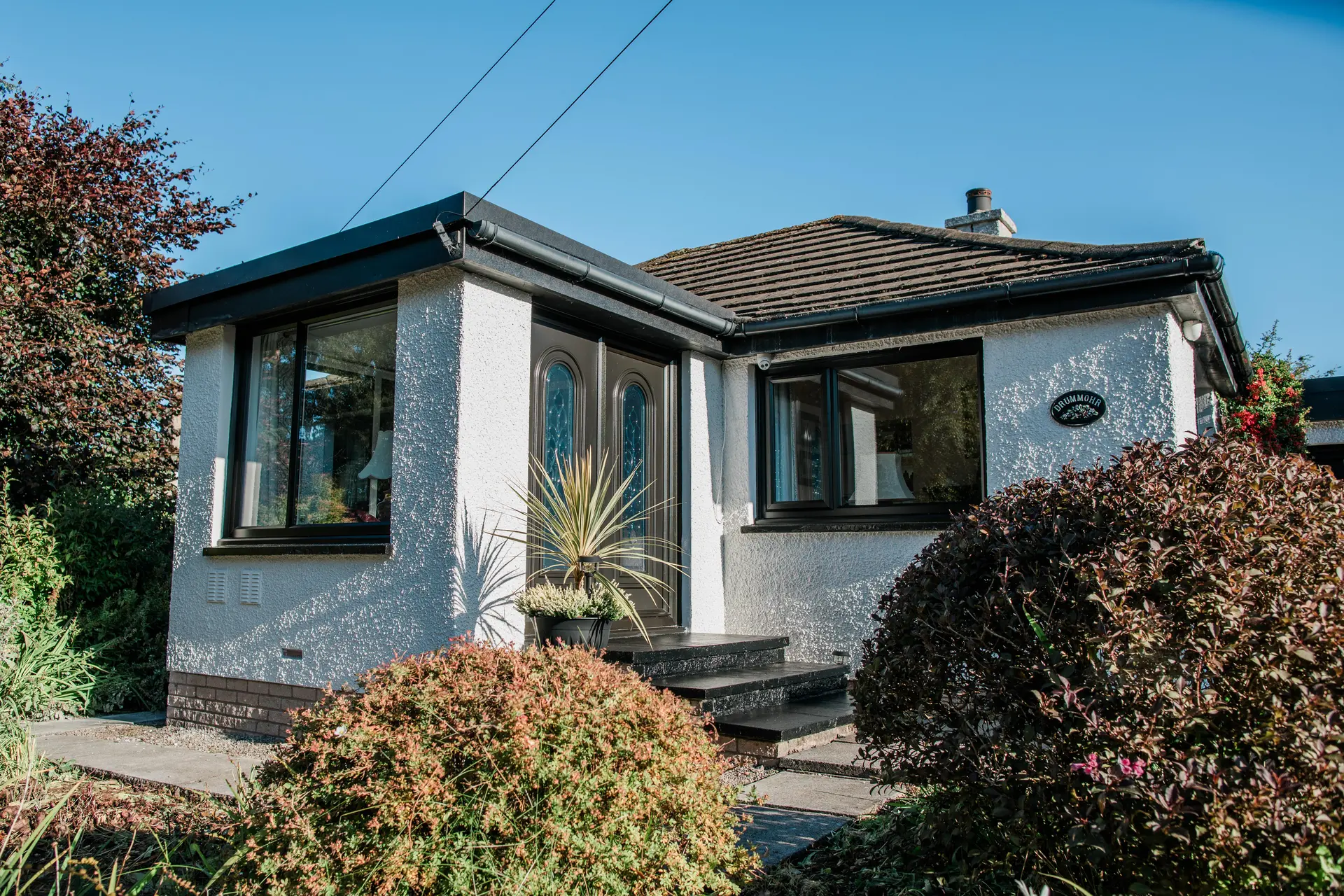 bugalow with brown french door and casement windows