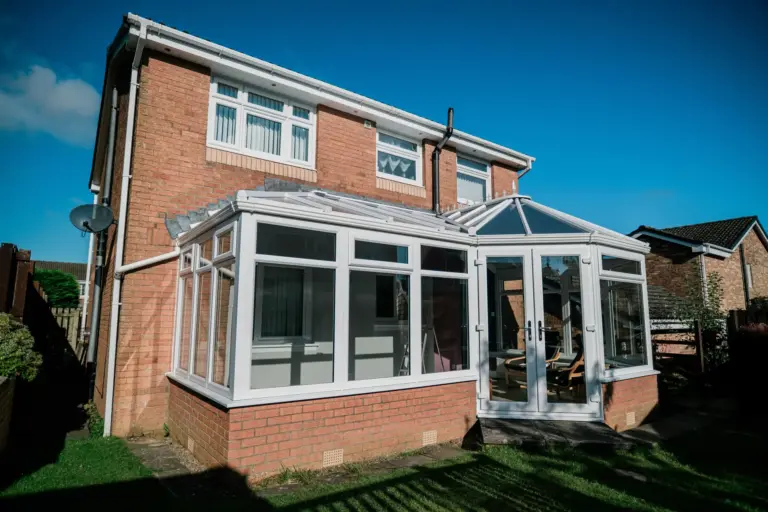 p shaped conservatory on red brick house