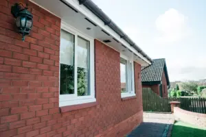 white casement windows on red brick house
