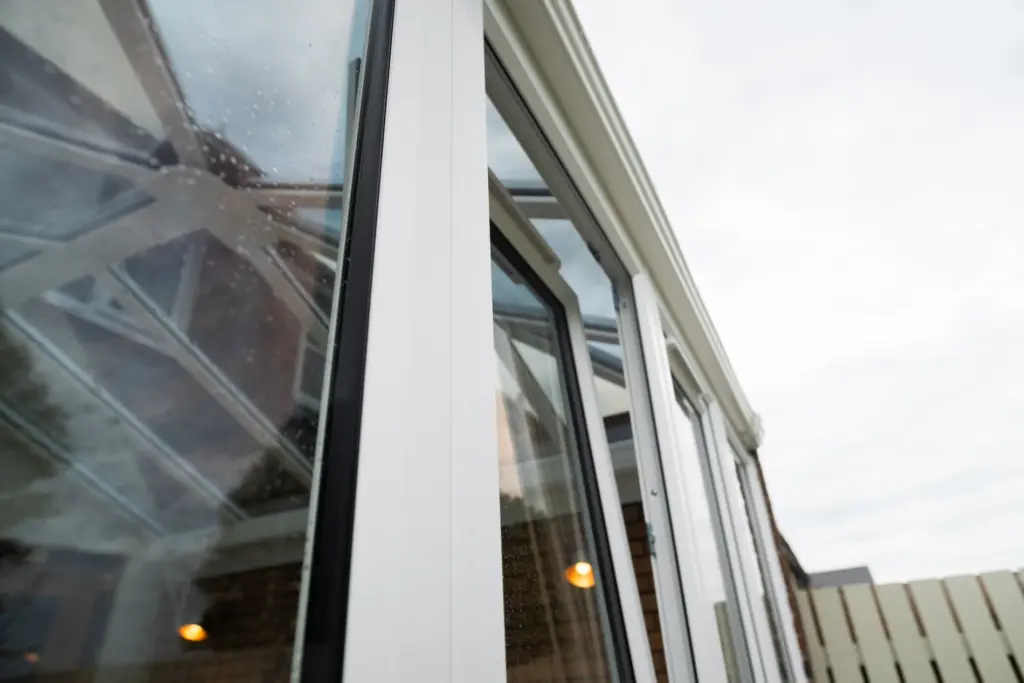 White conservatory frames and solar-controlled glass roof after replacement