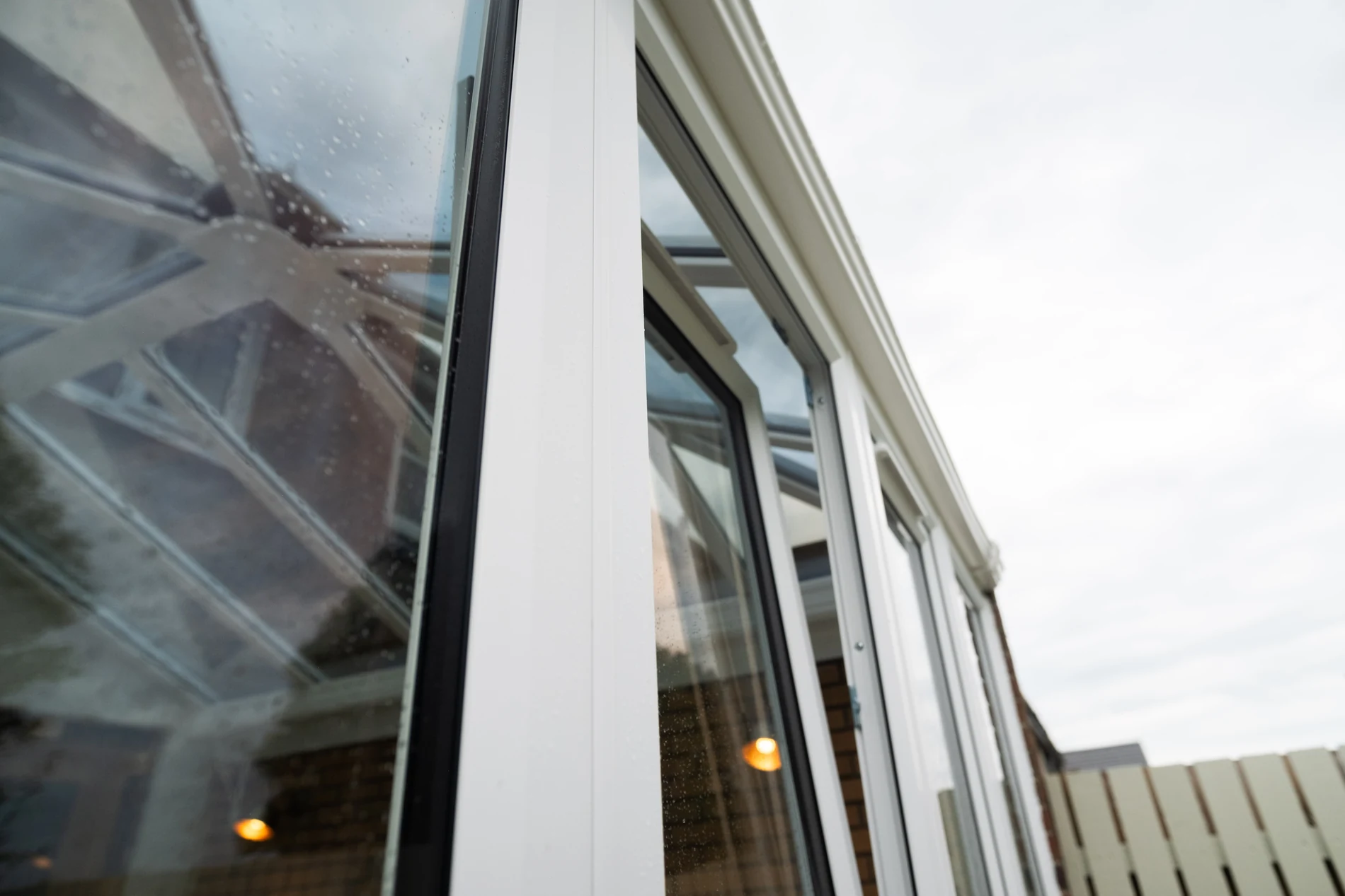 White conservatory frames and solar-controlled glass roof after replacement